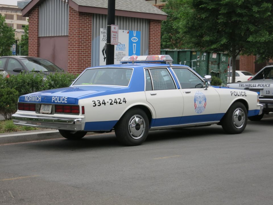 White and blue Norwich Police Chevrolet sedan rear three-quarter view