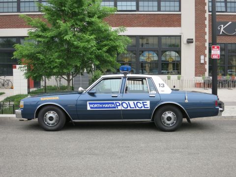 Dark blue and white North Haven Police Chevrolet sedan side view