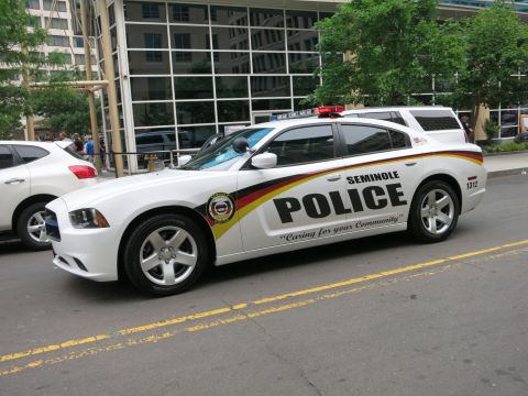 Front quarter view of a white Seminole Police Dodge Charger on a city street