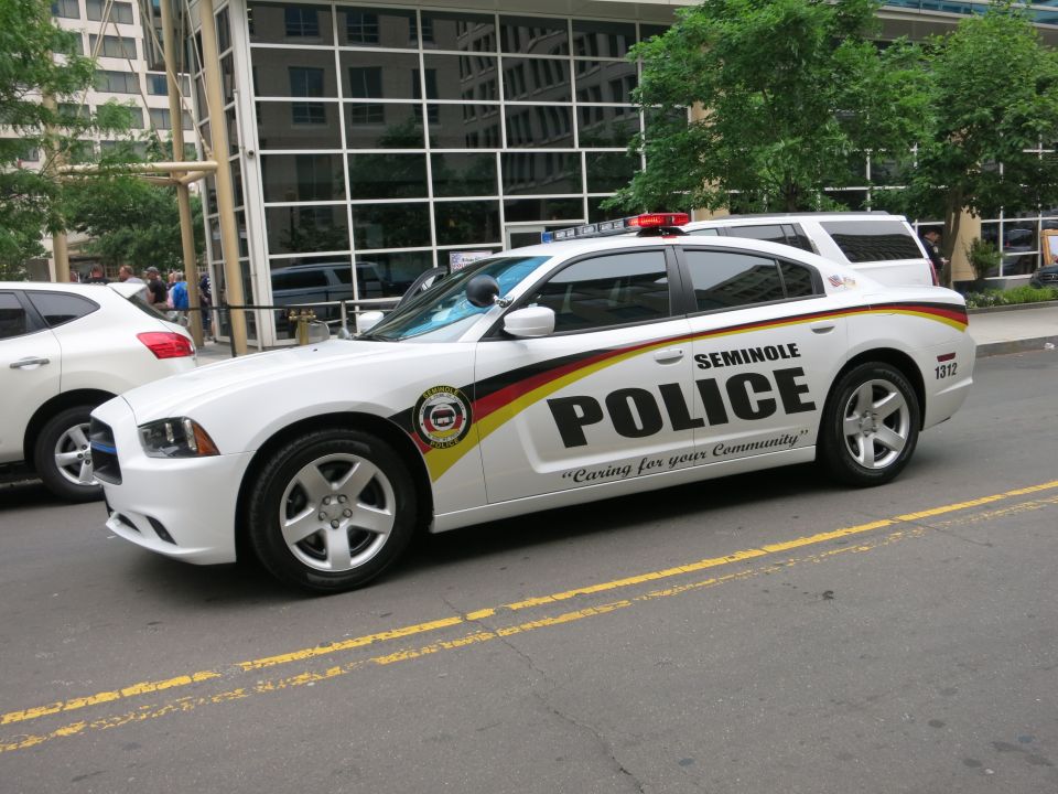 Front quarter view of a white Seminole Police Dodge Charger on a city street