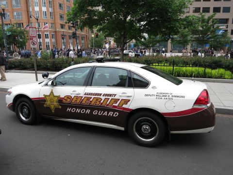 Side view of a Sangamon County Sheriff Honor Guard sedan in white and brown