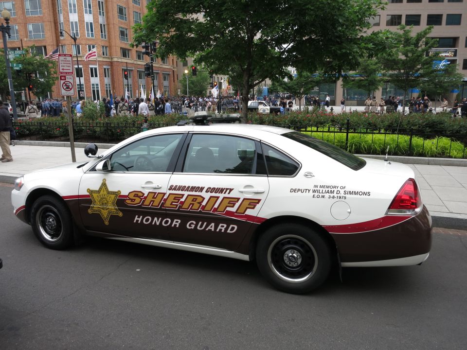 Side view of a Sangamon County Sheriff Honor Guard sedan in white and brown