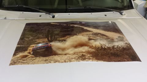 1996 Ford Bronco - Decal on a white vehicle's hood shows a red SUV navigating a dusty desert trail.