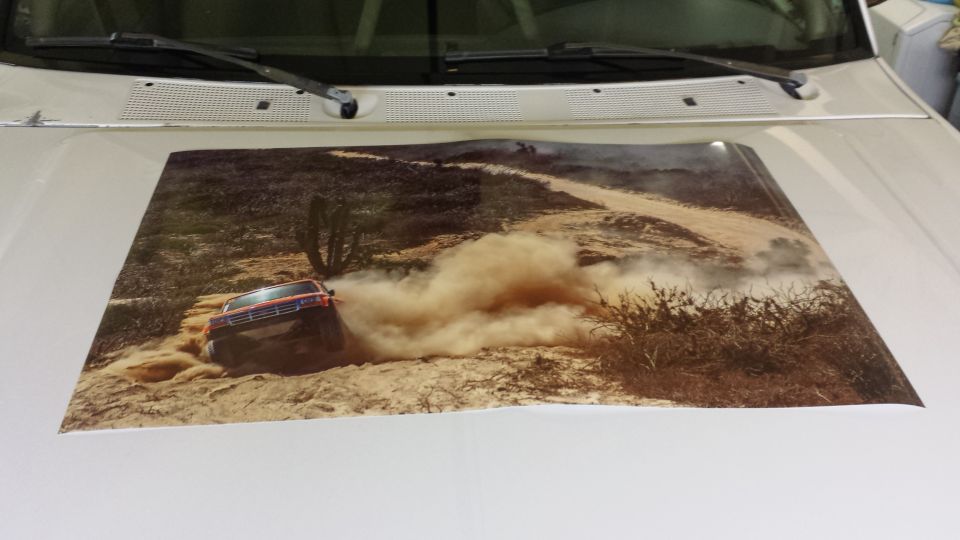 Decal of red SUV off-roading in desert