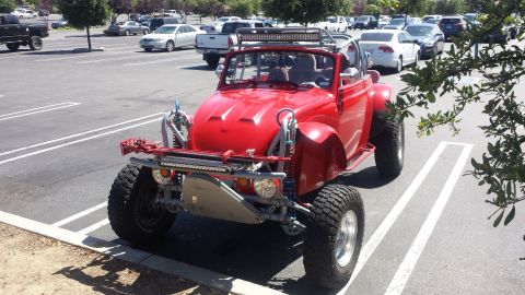 1996 Ford Bronco - Custom red dune buggy with off-road modifications and a light bar.