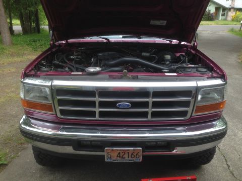 1992 Ford F-150 - Front view of a 1992 Ford F-150 with the hood open, revealing the engine bay.