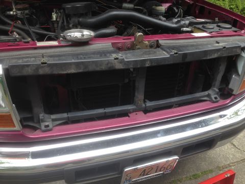 1992 Ford F-150 - Front view of a maroon 1992 Ford F-150 with the hood open, revealing the engine and grille assembly.