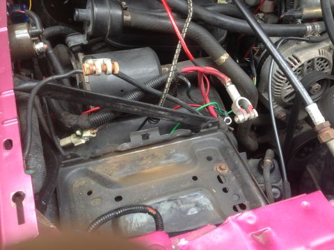 1992 Ford F-150 - Close-up view of the engine bay, focusing on the battery terminals and alternator, consistent with a 1992 Ford F-150.