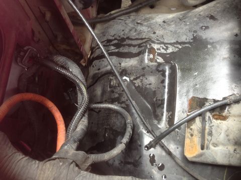 1992 Ford F-150 - Close-up view of engine bay wiring and metal components, showing signs of fluid leaks and wear.