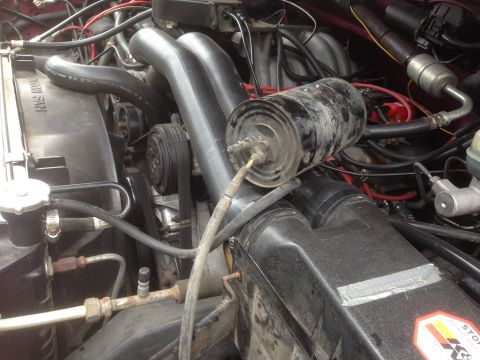 1992 Ford F-150 - Close-up view of an engine bay with prominent intake piping and engine components.