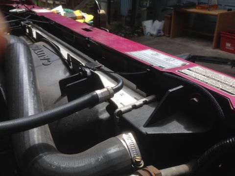 1992 Ford F-150 - Close-up view of engine bay components, including hoses and a purple metal panel with warning labels.