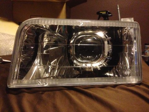 1992 Ford F-150 - Aftermarket projector headlight assembly shown up close, likely for a truck or SUV.