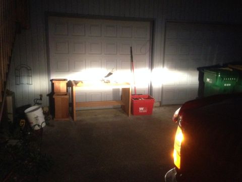 1992 Ford F-150 - The front corner of a red vehicle is visible, with its headlights illuminated.