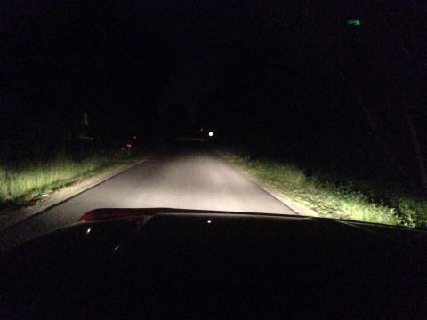1992 Ford F-150 - Driving at night with headlights on, illuminating the road ahead.