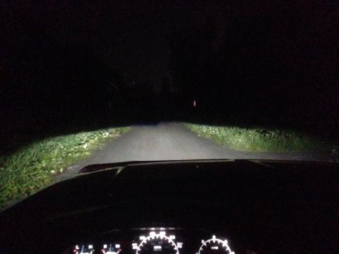 1992 Ford F-150 - The dashboard and illuminated road ahead are visible from the driver's perspective at night.