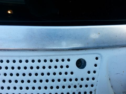 1992 Ford Bronco - starting from the top, I remove these phillips screws that hold the cowl down. There are 5 of them that run the length of the cowl.