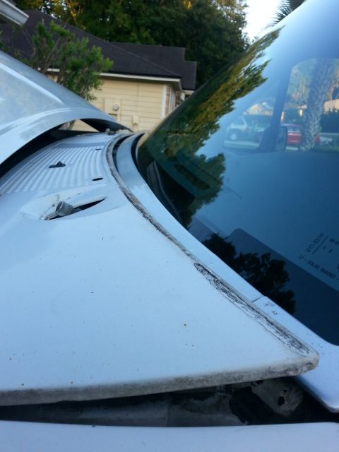 1992 Ford Bronco - The 1992 Ford Bronco's windshield cowl shows signs of age and potential water intrusion points.