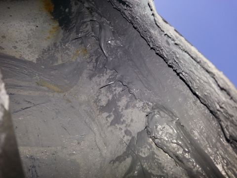 1992 Ford Bronco - This image shows a section of underbody sealant, possibly from a vehicle's firewall area, with visible rust.