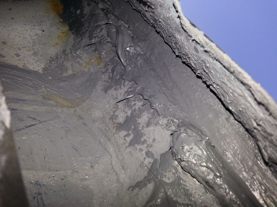 close-up of underbody sealant with some rust spots