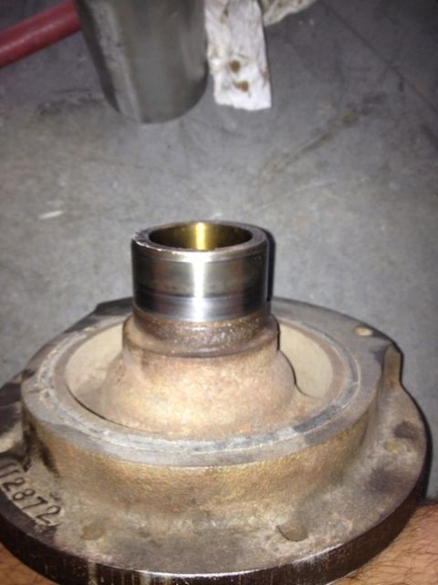 1961 International Scout 800 - A rusty crankshaft pulley with a bearing is shown, with part number 112872 visible on the casting.