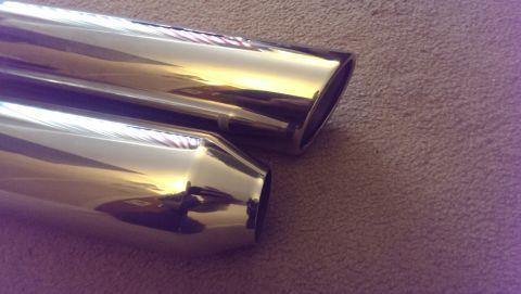 2000 Mercury Grand Marquis - Pair of chrome exhaust tips shown on a carpeted surface.