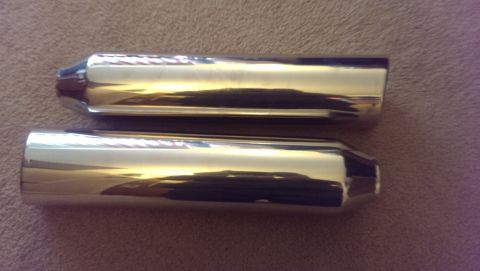 2000 Mercury Grand Marquis - Two chrome exhaust tips are shown, reflecting light on a textured surface.