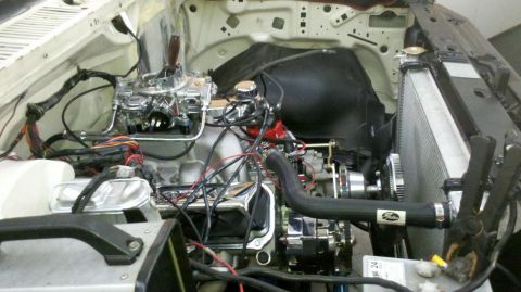 1982 Ford Bronco - The engine bay features a chrome carburetor, a large radiator, and a Gates branded hose, suggesting a custom build or restoration.