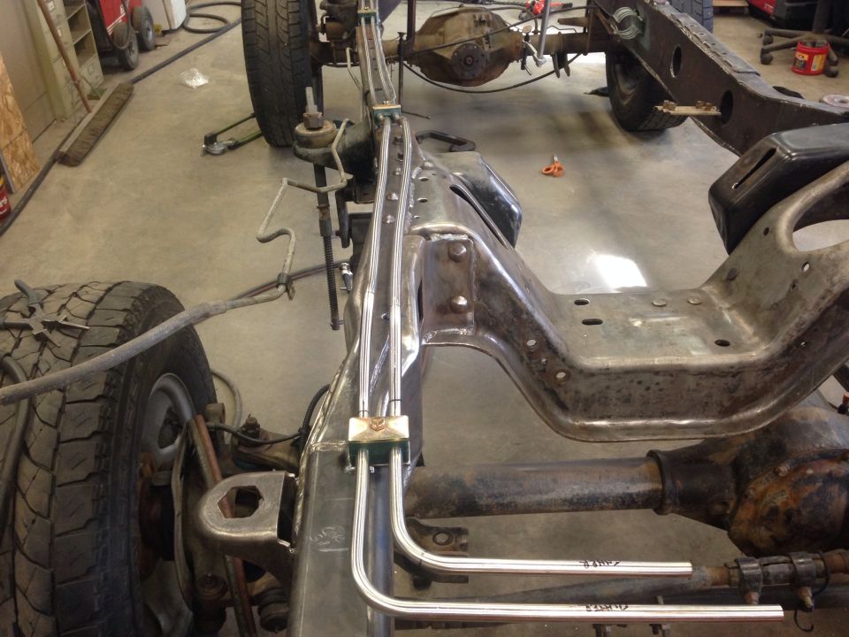 Close-up of vehicle frame and suspension with brake lines