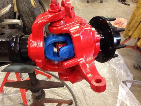 1993 Ford Bronco - A close-up view of a freshly painted front axle assembly, likely undergoing restoration or repair.
