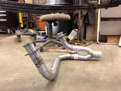 1993 Ford Bronco - Custom exhaust pipe system laid out on a workshop floor.