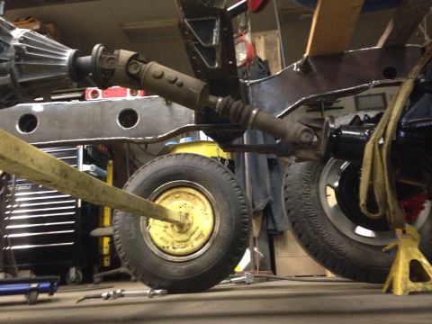 1993 Ford Bronco - Close-up view of a vehicle's undercarriage, showing the driveshaft and suspension components during repair.
