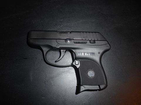 1994 Ford Bronco - A black Ruger pistol is shown against a dark background.