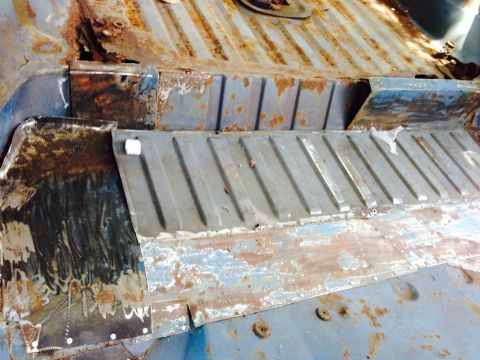 1979 Ford Bronco - Interior floor pan showing extensive rust and repair work.