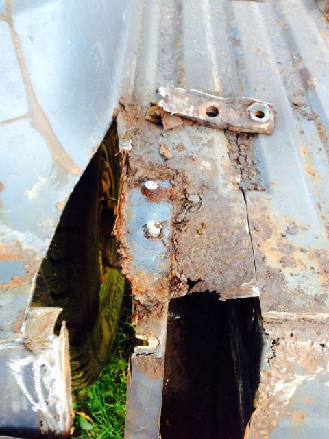 1979 Ford Bronco - This image shows significant rust damage to a vehicle's frame and wheel well, obscuring specific identification details.