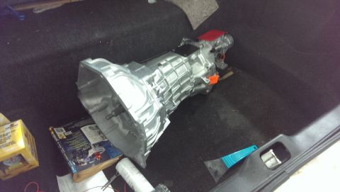 2000 Mercury Grand Marquis - A manual transmission is shown resting on a carpeted surface, possibly a vehicle's interior.