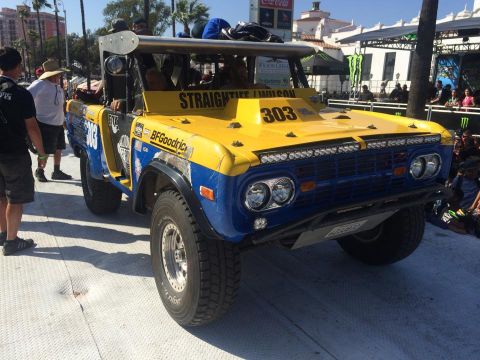 1990 Ford Bronco - This off-road Bronco, likely from the early 1970s, features extensive racing decals and a prominent number 303 on its hood.