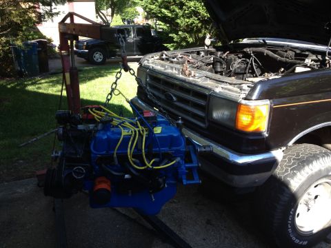 1988 Ford Bronco - Engine removal in progress for a 1987 Ford F-Series truck, with a second truck visible in the background.