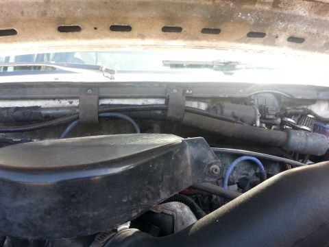1992 Ford Bronco - This image shows a section of a vehicle's engine bay, focusing on various hoses and wiring harnesses.