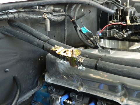 1979 Ford Bronco - Close-up of engine bay components including hoses and a carburetor.