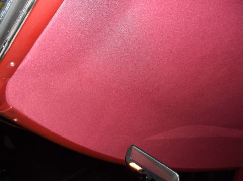 1979 Ford Ranchero - The textured red headliner of a vehicle is shown, with a rearview mirror at the bottom right.