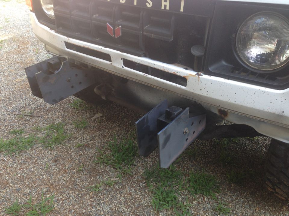 Front of a Mitsubishi Pajero with custom metal brackets attached to the bumper