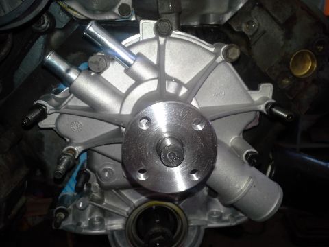 1991 Ford F-250 - A new water pump is installed on the engine, ready to circulate coolant.