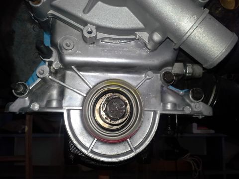 1991 Ford F-250 - Close-up view of an engine water pump assembly, showing mechanical components and silver metalwork.