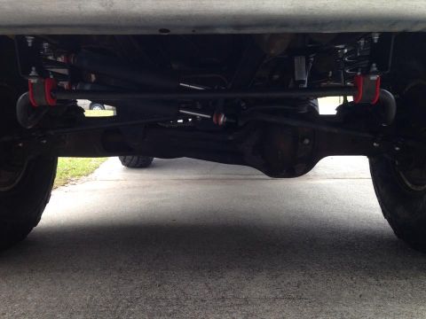 1994 Ford Bronco - Undercarriage view of a vehicle's suspension and rear differential.