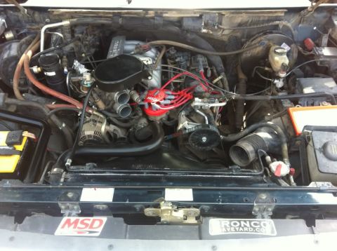 1994 Ford Bronco - The engine bay shows aftermarket MSD ignition parts and a Ronco Supermotors sticker.