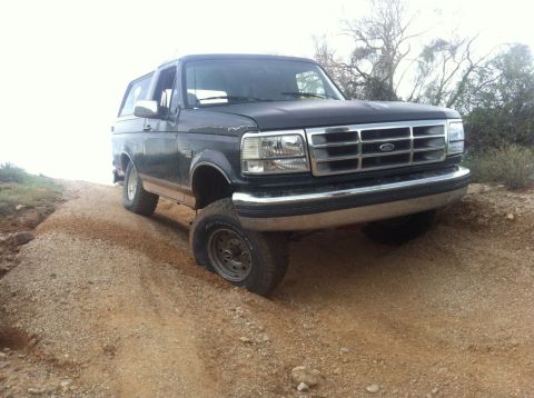 1994 Ford Bronco - This 1994 Ford Bronco is navigating a rough dirt path.