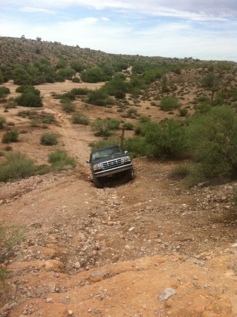 1994 Ford Bronco - This 1994 Ford Bronco navigates a desert landscape on a dirt path.