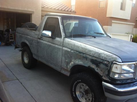1994 Ford Bronco - This Ford Bronco shows significant wear and tear, with primer visible through the paint.