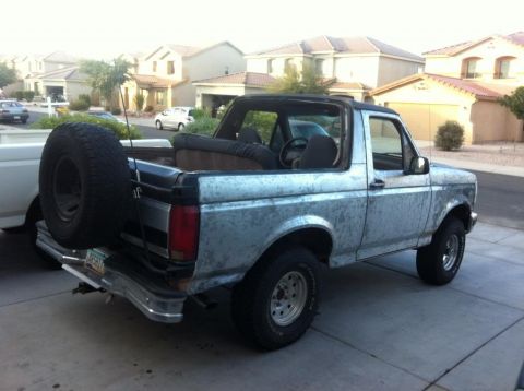 1994 Ford Bronco - This Ford Bronco is parked in a suburban driveway with houses in the background.