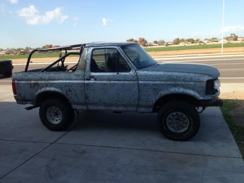 1994 Ford Bronco - This 1994 Ford Bronco has a custom roll cage installed and shows significant wear.